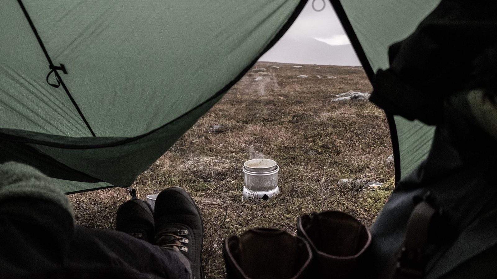 View from tent of outdoor cooking in Jämtlands, Sweden, perfect for hiking and camping enthusiasts.