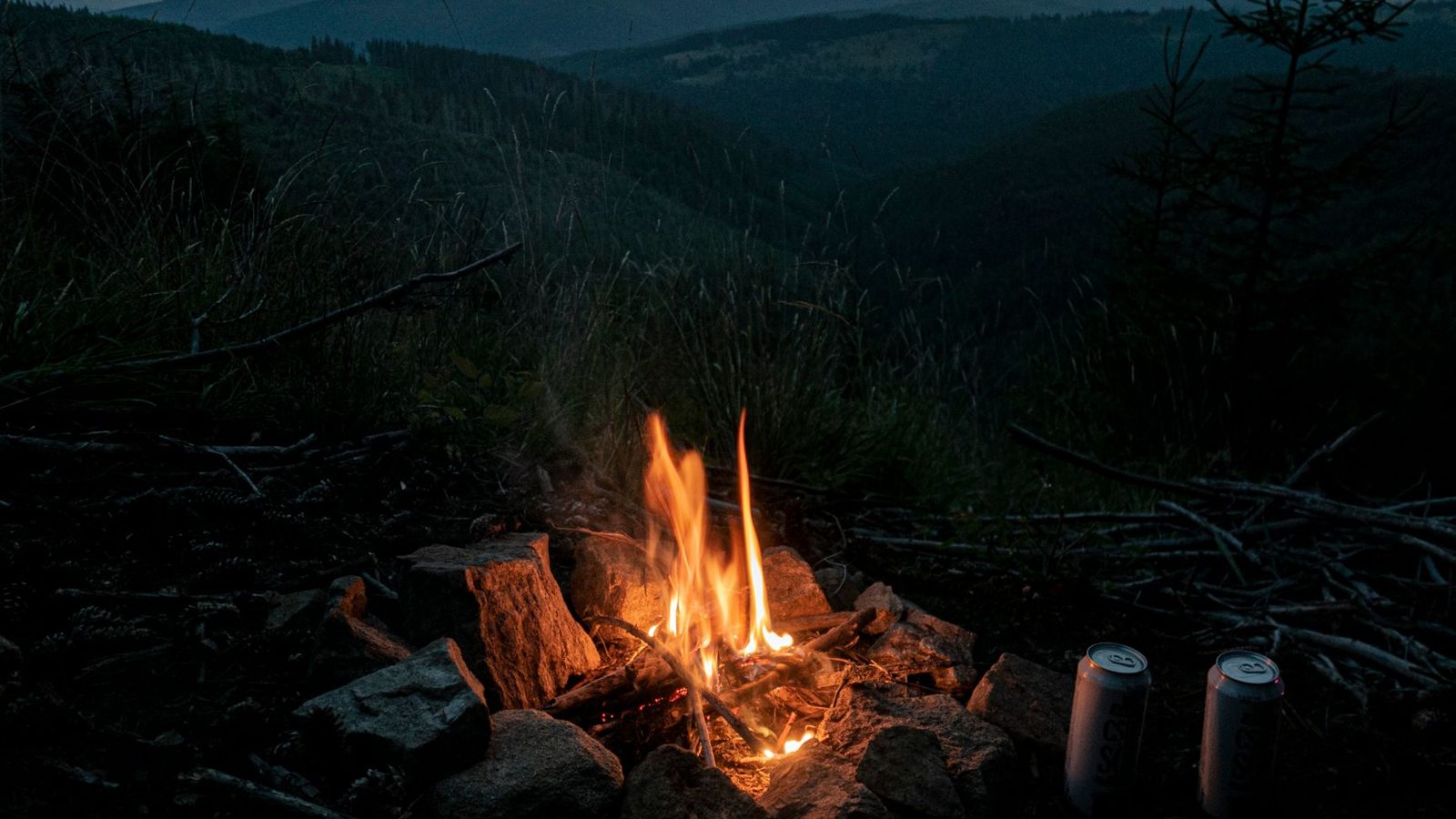 Serene campfire in Romanian hills during evening, offering warmth and tranquility.